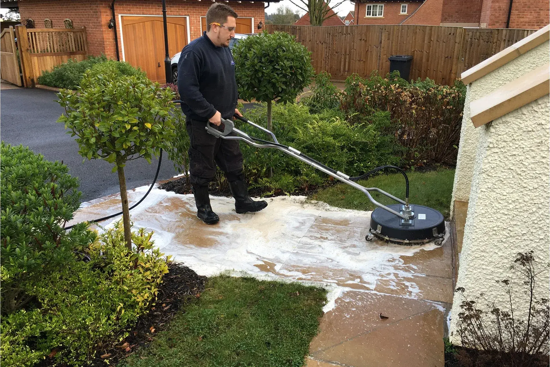 Professional pressure washing a residential driveway in Leighton Buzzard